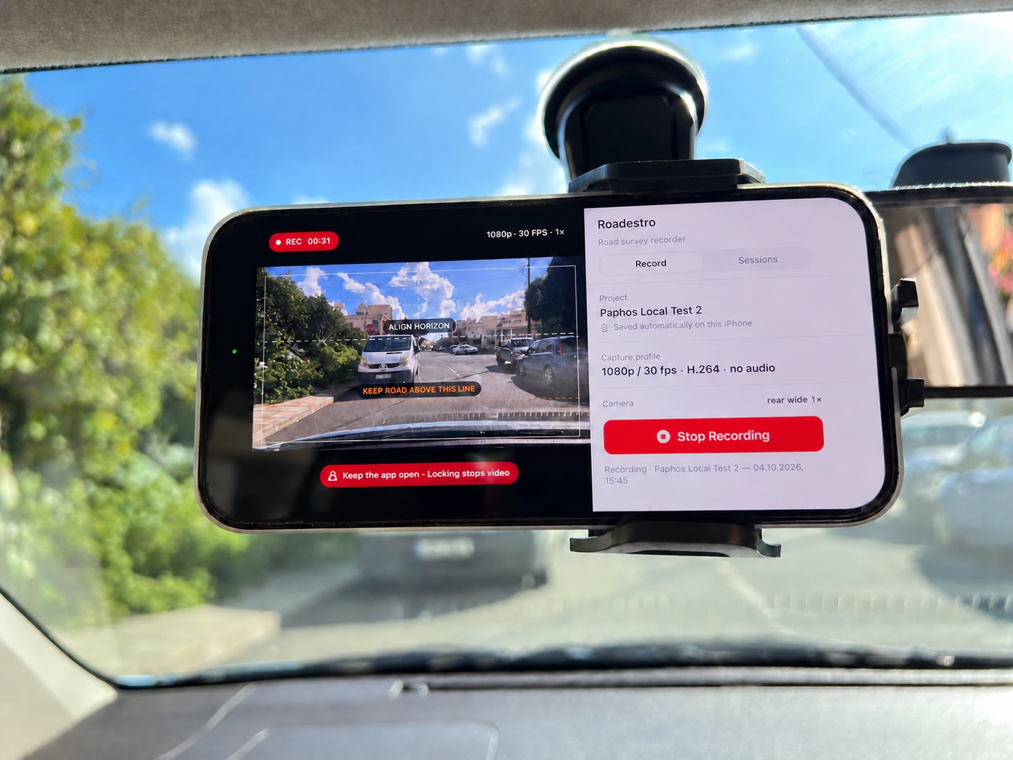 An iPhone secured to a windscreen mount while recording a road in Paphos